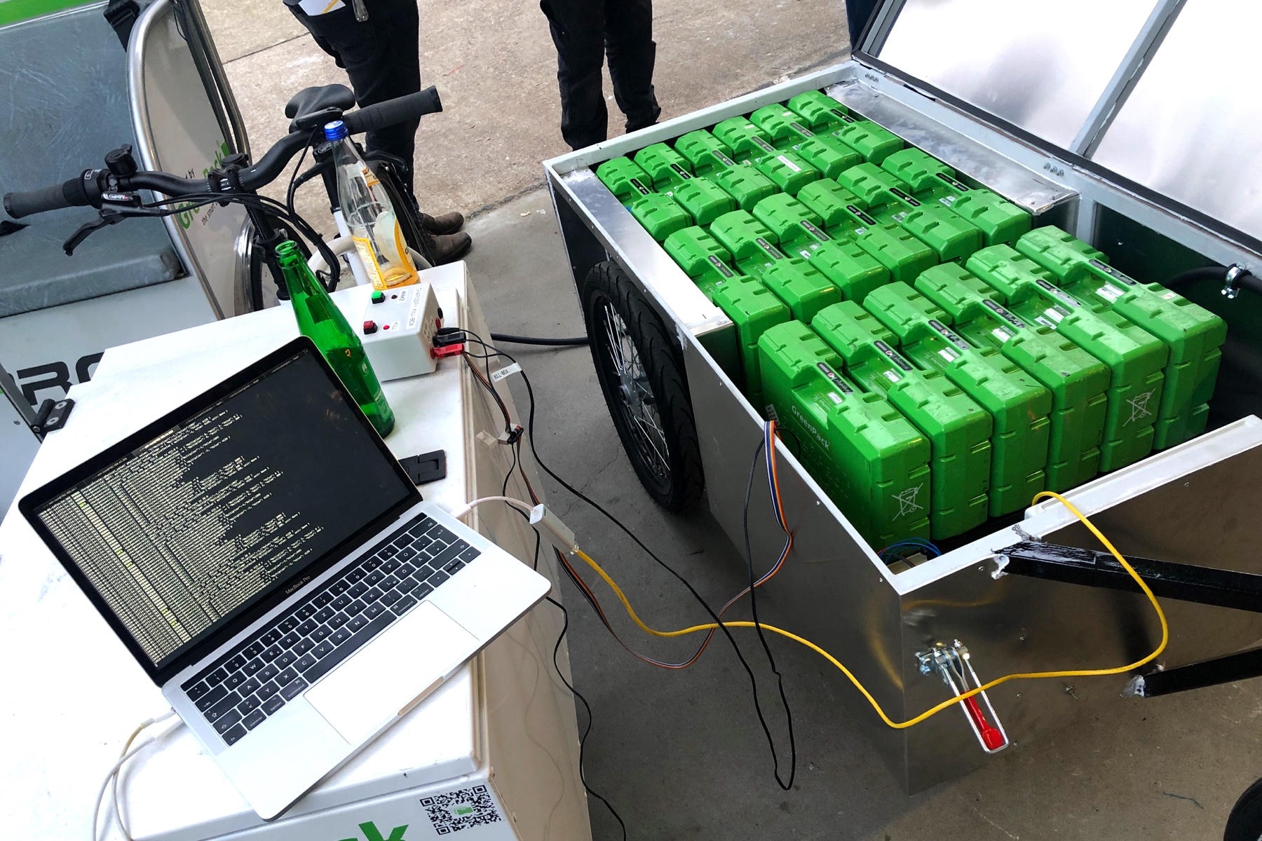 The Chargery mobile EV charging system, connected to a laptop showing terminal output